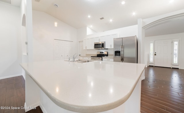 kitchen with sink, stainless steel appliances, dark hardwood / wood-style flooring, high vaulted ceiling, and white cabinets