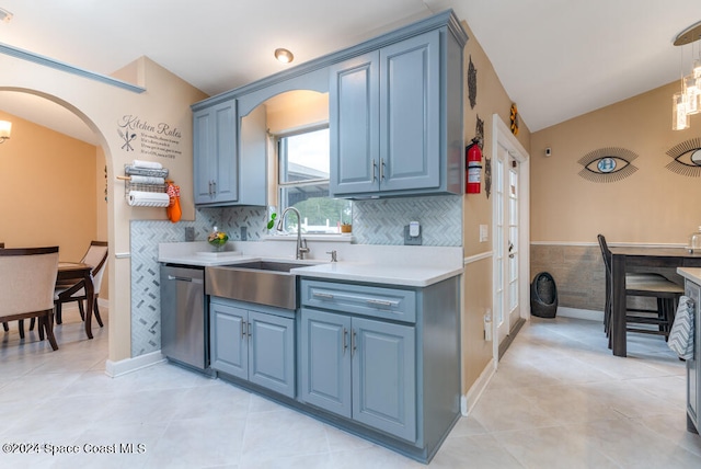 kitchen with stainless steel dishwasher, decorative light fixtures, light tile patterned flooring, and sink