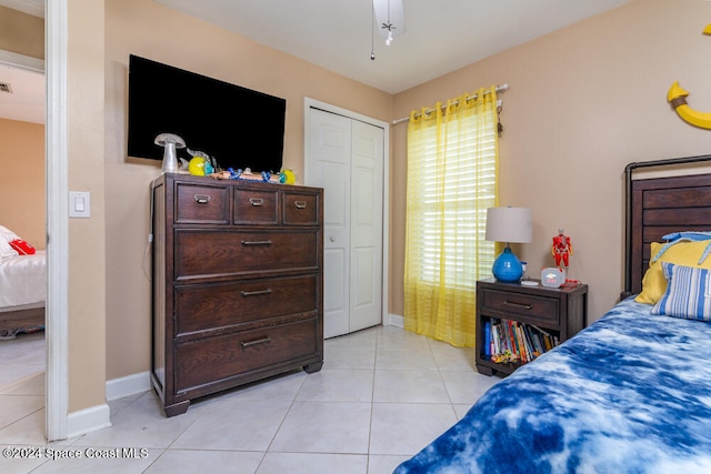 tiled bedroom with a closet