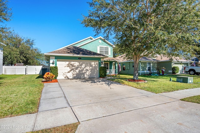 view of front of house featuring a front yard and a garage