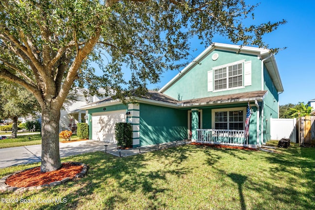 view of front of property with a front yard, a porch, and a garage