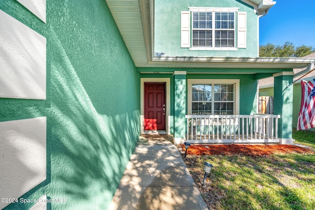 doorway to property featuring a porch