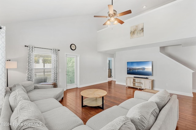 living room with hardwood / wood-style floors, high vaulted ceiling, and ceiling fan