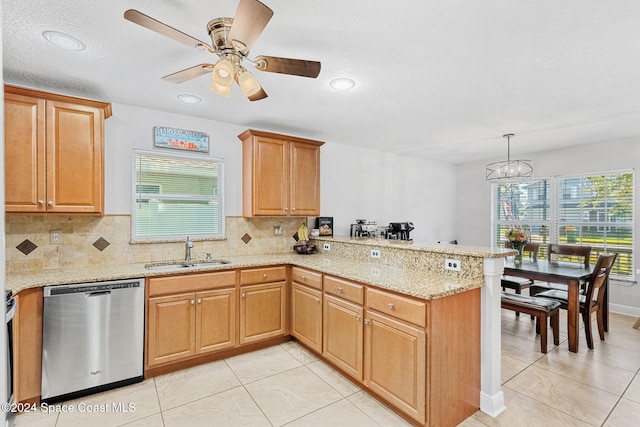 kitchen featuring dishwasher, backsplash, sink, hanging light fixtures, and kitchen peninsula