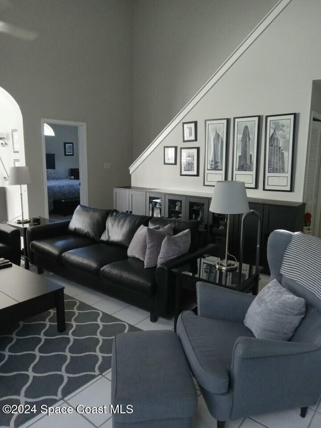 living room featuring a high ceiling and light tile patterned flooring