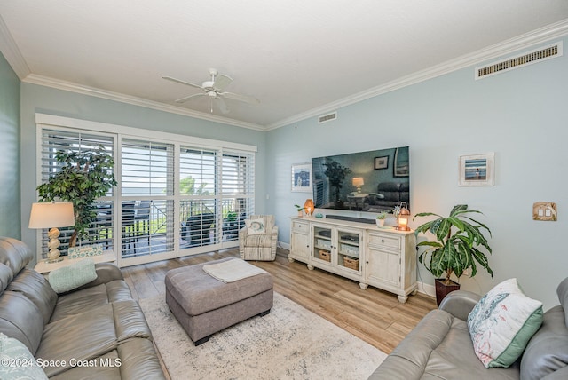 living room with ceiling fan, light wood-type flooring, and crown molding