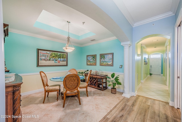 dining space with ornamental molding and ornate columns