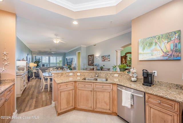 kitchen with ornate columns, light stone countertops, sink, and stainless steel dishwasher