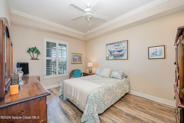 bedroom with wood-type flooring, ceiling fan, and ornamental molding