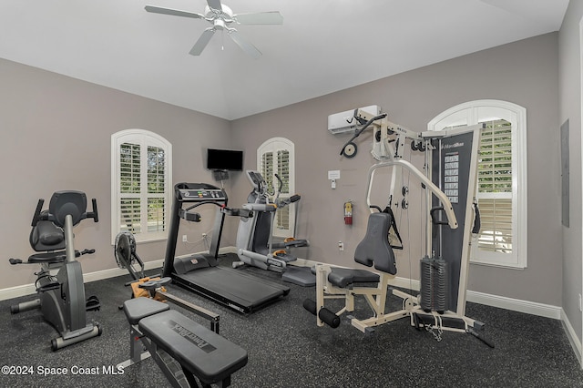 exercise room with a wall unit AC, ceiling fan, and lofted ceiling