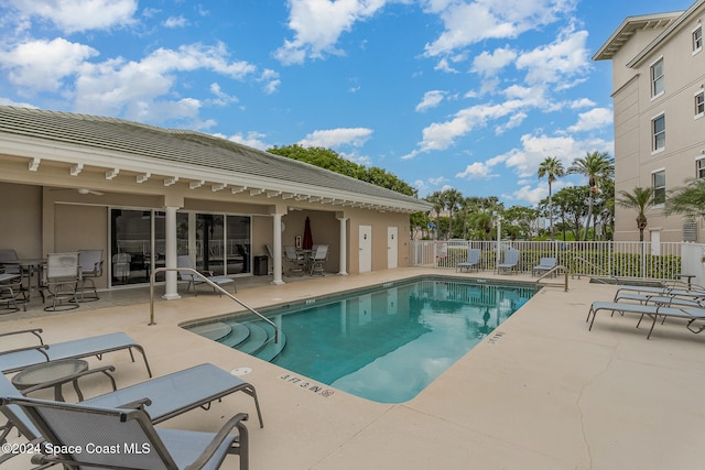 view of pool with ceiling fan and a patio