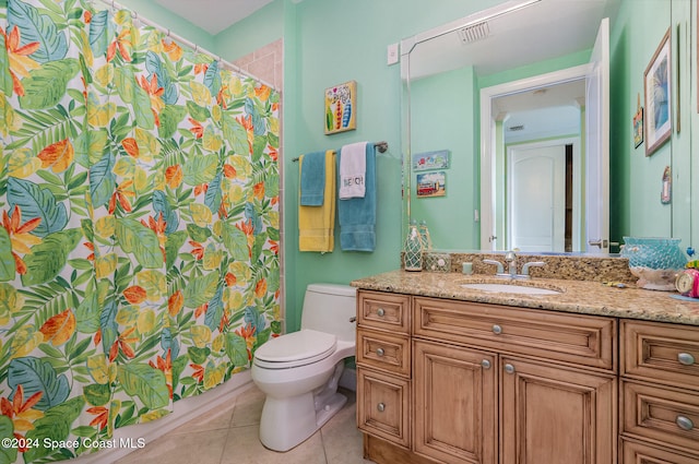 bathroom with tile patterned floors, walk in shower, vanity, and toilet