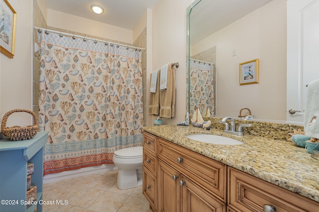 bathroom featuring tile patterned flooring, vanity, and toilet