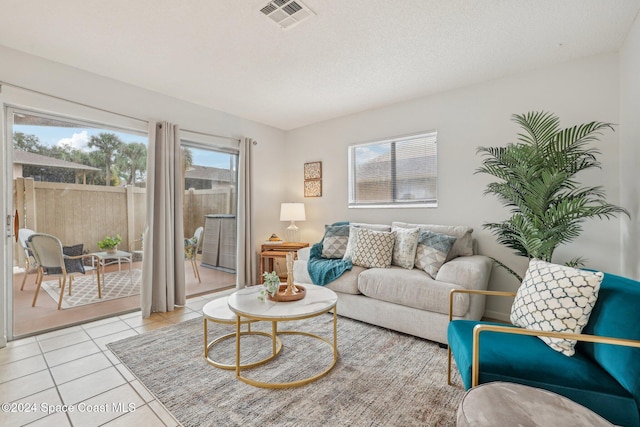 living room with light tile patterned floors and a textured ceiling