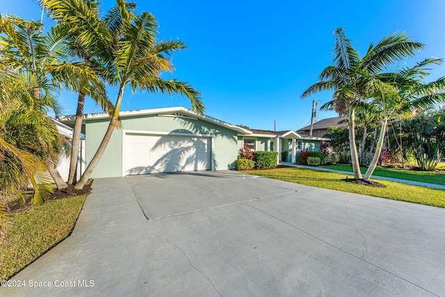 view of front of property featuring a garage and a front yard