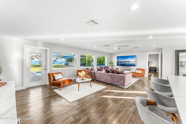 living room with hardwood / wood-style flooring and ceiling fan