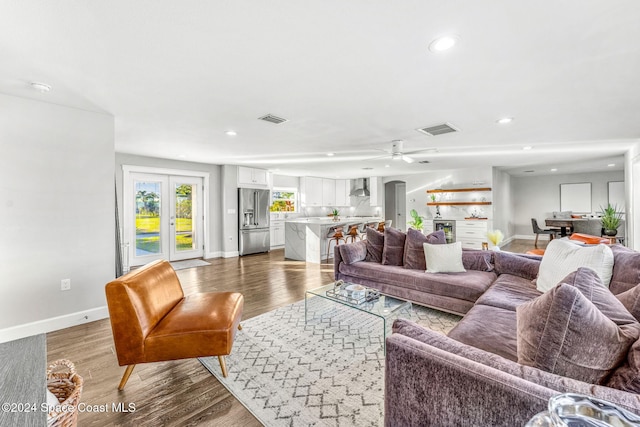 living room with ceiling fan and light hardwood / wood-style floors