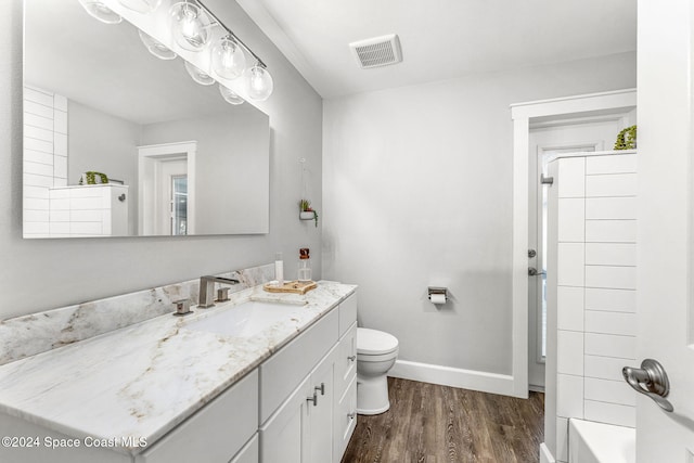 full bathroom with shower / bathing tub combination, wood-type flooring, vanity, and toilet