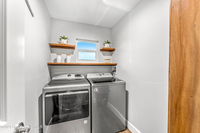 clothes washing area featuring washer and clothes dryer