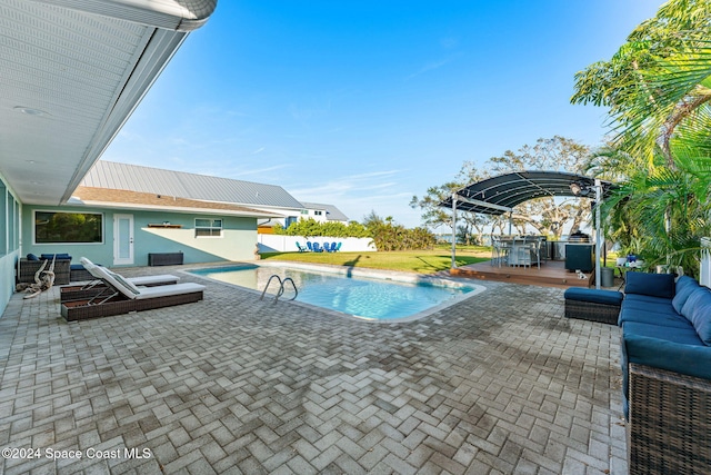 view of pool featuring an outdoor living space, a patio, and a deck