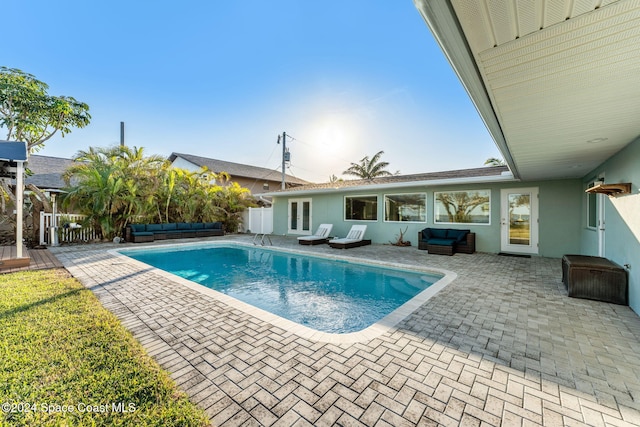 view of swimming pool with an outdoor living space and a patio area