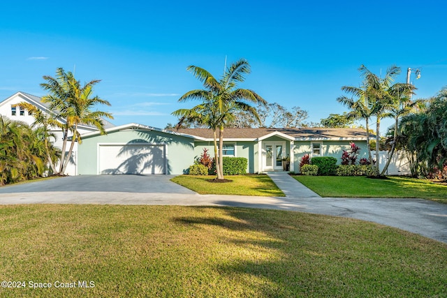 view of front of property with a garage and a front lawn