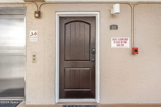 entrance to property featuring elevator