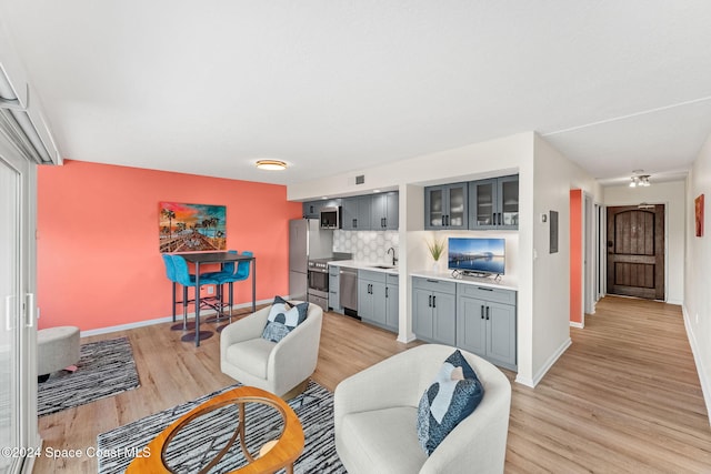 living room featuring light hardwood / wood-style flooring and sink