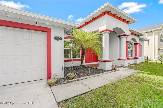 view of front of home featuring a garage and a front lawn