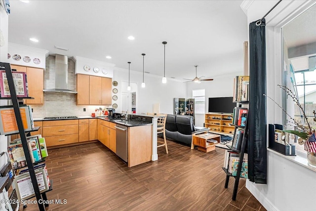 kitchen featuring kitchen peninsula, wall chimney exhaust hood, light brown cabinets, dishwasher, and dark hardwood / wood-style floors