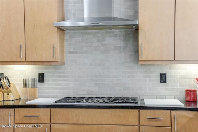 kitchen with backsplash, wall chimney exhaust hood, and stainless steel gas cooktop