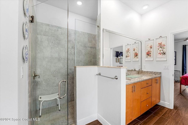 bathroom with vanity, wood-type flooring, and walk in shower