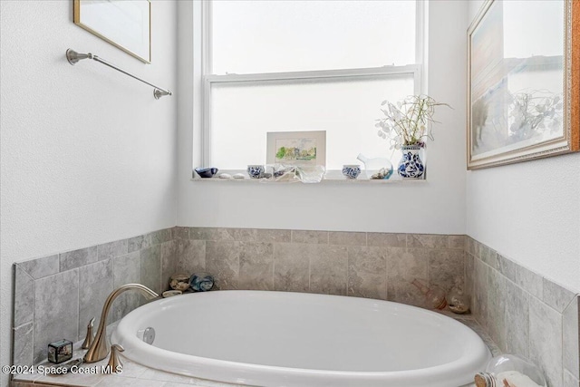 bathroom featuring tiled bath