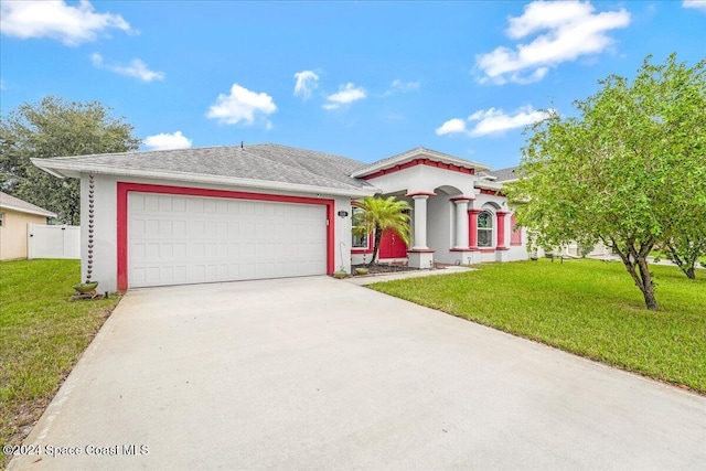 view of front of home with a garage and a front lawn