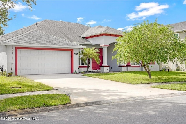 view of front of home featuring a front lawn and a garage