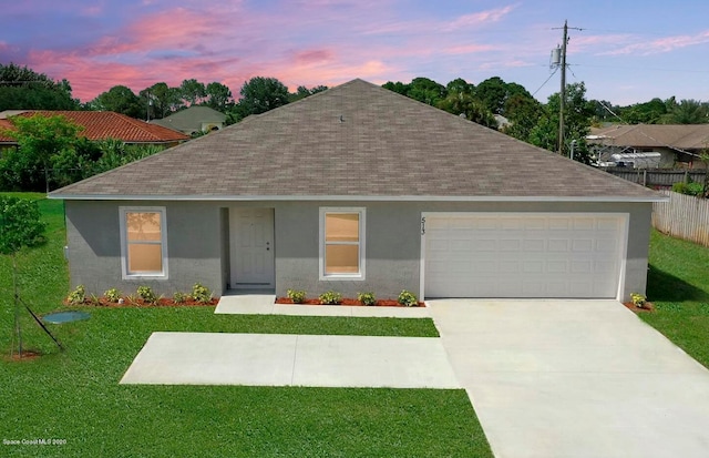 single story home with a yard and a garage