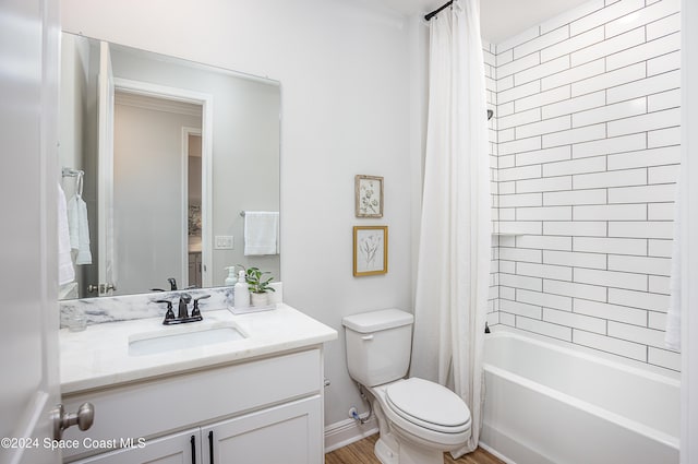 full bathroom with hardwood / wood-style floors, vanity, toilet, and shower / bath combo with shower curtain