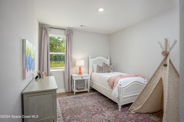 bedroom with dark hardwood / wood-style flooring