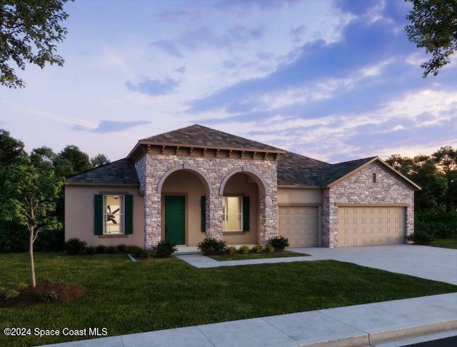 view of front of home featuring a yard and a garage