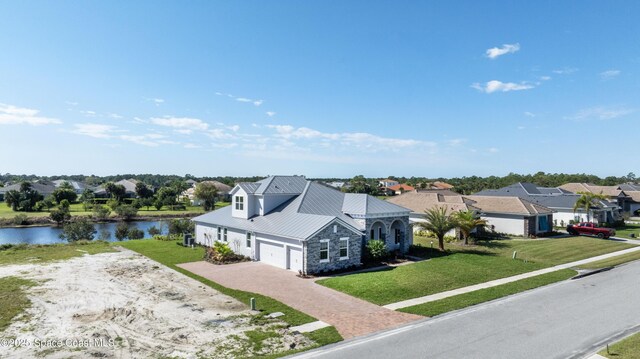 birds eye view of property with a residential view and a water view