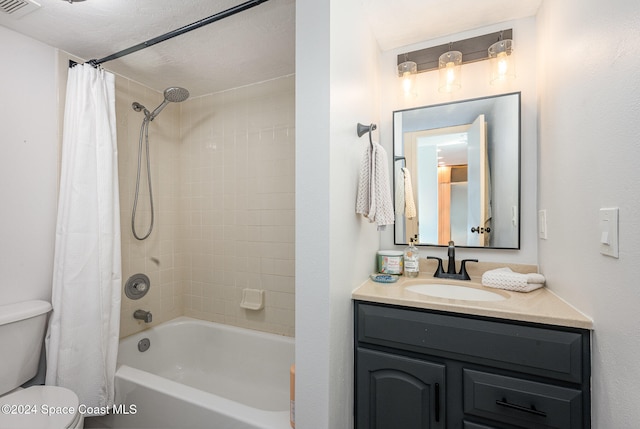 full bathroom with a textured ceiling, vanity, shower / bath combo, and toilet