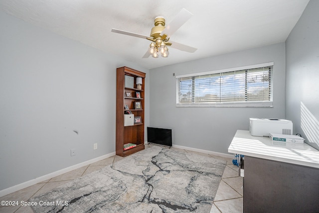 tiled office space featuring ceiling fan