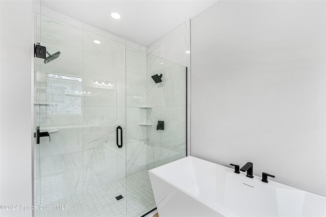 bathroom with separate shower and tub