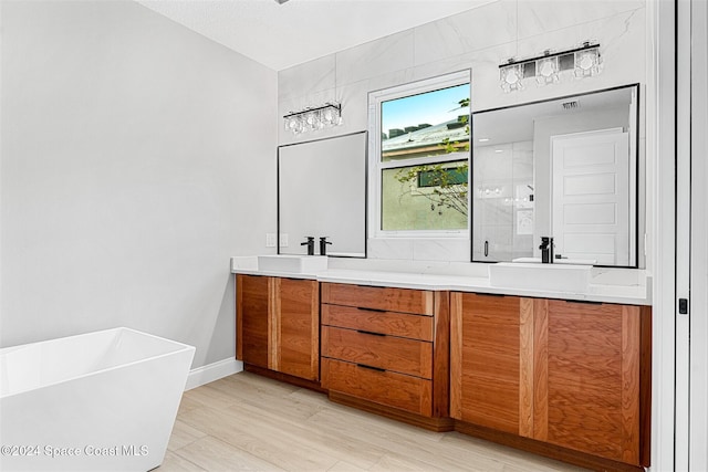 bathroom featuring plus walk in shower, wood-type flooring, and vanity