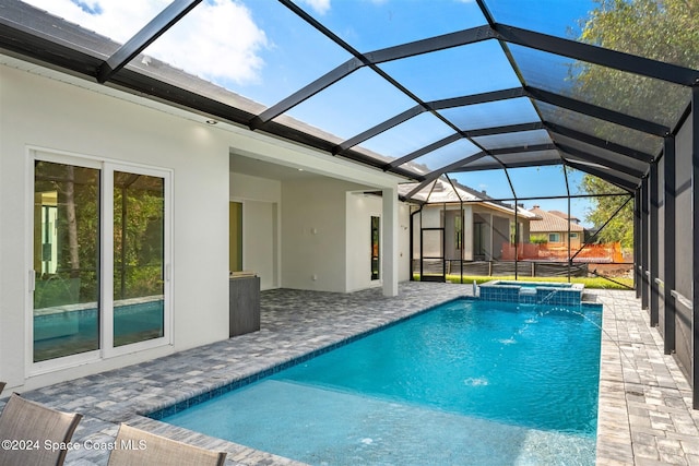 view of swimming pool with pool water feature, a lanai, and an in ground hot tub