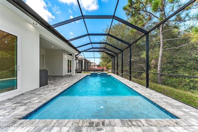 view of swimming pool featuring a lanai, a patio area, and pool water feature