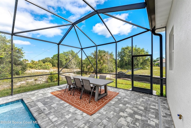 view of patio / terrace featuring a lanai