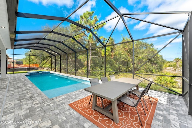 view of swimming pool with pool water feature, a patio area, and a lanai