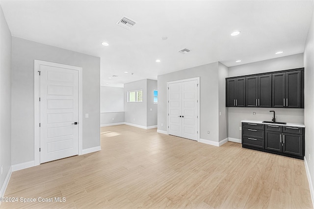 kitchen with light hardwood / wood-style floors and sink