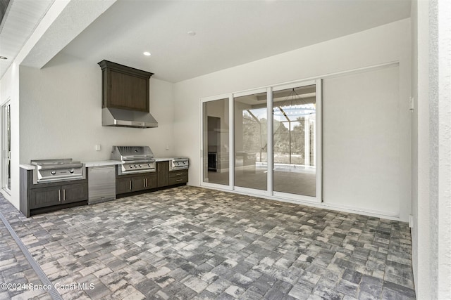 interior space featuring wall chimney exhaust hood, dark brown cabinets, and fridge